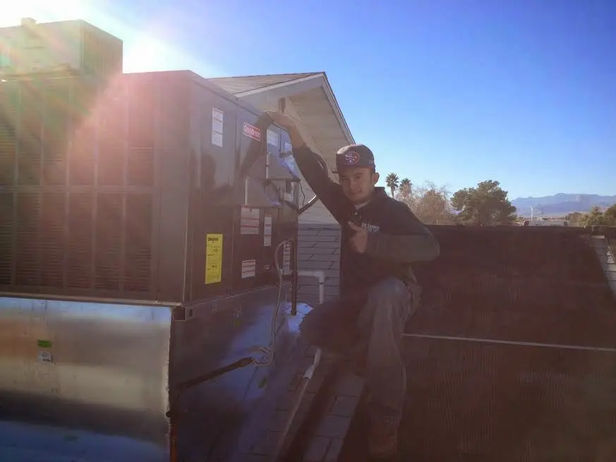 HVAC technician performing AC Tune-Up on a rooftop unit in Kingfisher
